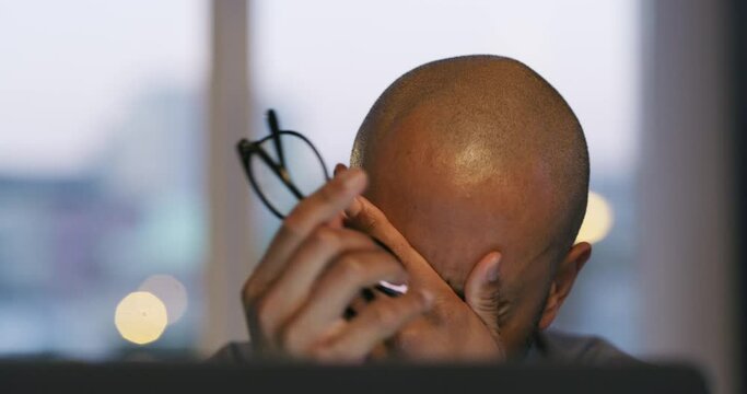 Tired, stress and businessman with glasses at night in office with burnout while thinking of bankruptcy. Face of a depressed male entrepreneur working late on problem, deadline or crisis at computer