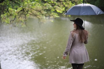 Young girl in a coat in a spring park