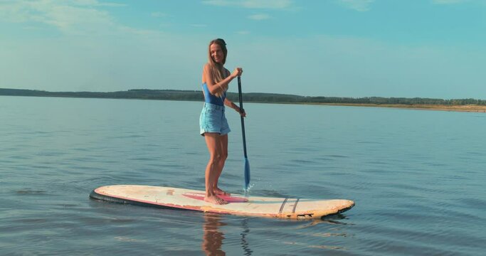 Fit Happy Blonde Woman Swim Surfing Boat Fitness Workout Travel Water Tourism Holiday Vacation. Sport Recreation Sup Fun Rowing. Woman Floating Sup Board Tourist Floating Standup Paddle Board