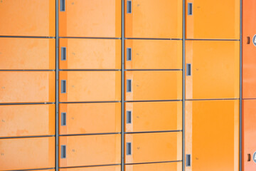orange color storage box in public place. safe storage locker for shopping malls
