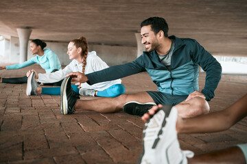 Group, workout and people stretching as a fitness club for sports, health and wellness in an urban town together. Sport, smile and happy friends training or team doing warm up exercise in a city
