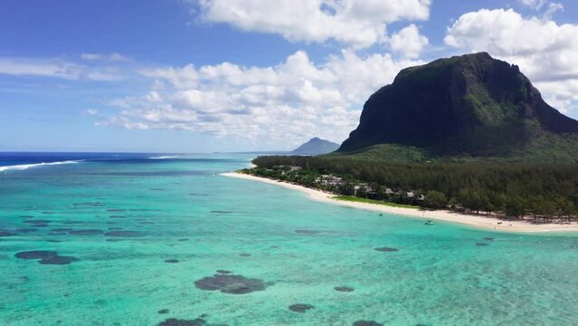 Turquoise clean lagoons protected by coral reefs of Le Morne peninsula with basalt mount on Mauritius island. Also a wonderful kiteboarding and windsurfing spot. Exotic traveling aerial 4K video.