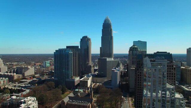 Aerial Shot Of Buildings In City Against Blue Sky On Sunny Day, Drone Flying Backward Over Modern Cityscape - Charlotte, North Carolina
