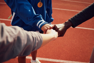People, diversity and fist bump in fitness for unity, trust or support together on stadium track....