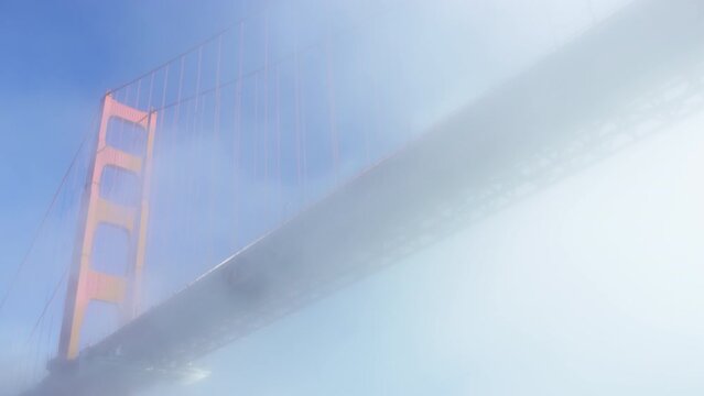 Tilt down from Golden Gate Bridge to support, from underneath in slow motion