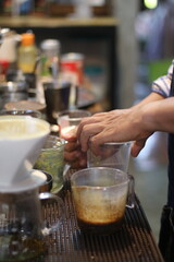 barista making a cup of coffee in the coffee shop