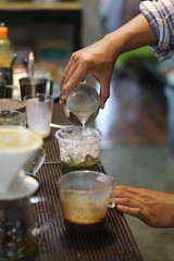 barista making a cup of coffee in the coffee shop