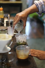 barista making a cup of coffee in the coffee shop