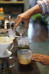 barista making a cup of coffee in the coffee shop