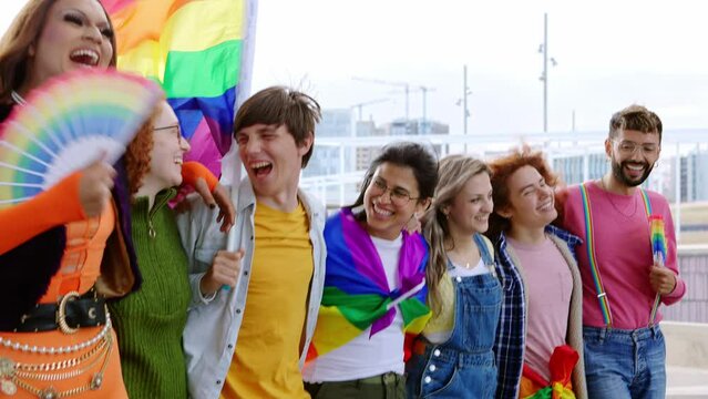 Diverse group of homosexual people having fun celebrating gay pride festival together. LGBTQIA community concept
