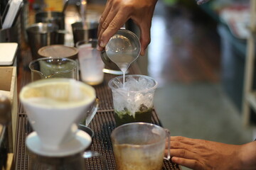 barista making a cup of coffee in the coffee shop