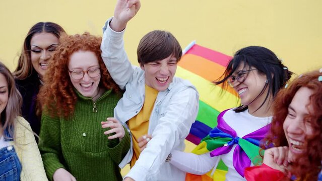 Young friends celebrating gay pride day festival. Diverse group of homosexual and bisexual people having fun at gay pride event. LGBTQI community concept.