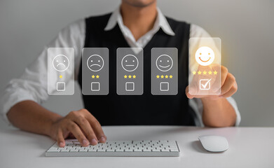 Businessman pressing face emoticon rating on virtual touch screen to service experience. Customer...