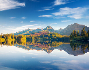 An incredible view of the calm lake Strbske pleso, surrounded by mountains. National Park High Tatra, Slovakia, Europe.