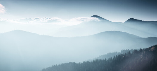 The peaks of the mountains are visible through the haze in the distance at dawn.
