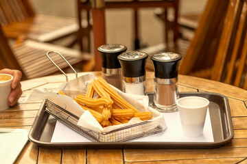 A churro is a type of fried dough from Spanish and Portuguese cuisine, made with choux pastry dough piped into hot oil with a piping bag and large closed star tip or similar shape.