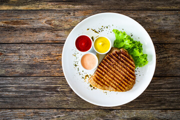 Grilled beef steak on wooden table