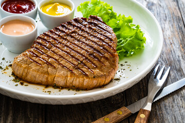 Grilled beef steak on wooden table