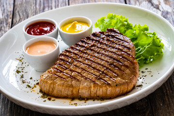 Grilled beef steak on wooden table