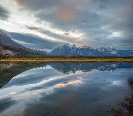 Landscape with mountain range reflecting in a lake at sunset, Jasper National Park, Canada