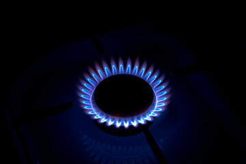 Kitchen gas cooker with burning fire gas. Blue flame of a gas burner