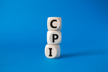 CPI - Consumer Price Index symbol. Concept word CPI on wooden cubes. Beautiful blue background. Business and CPI concept. Copy space.