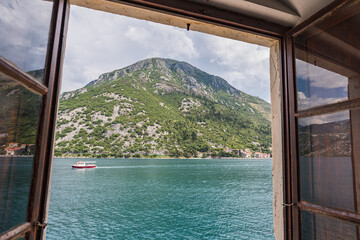 Fototapeta na wymiar Boat travels along the Bay of Kotor
