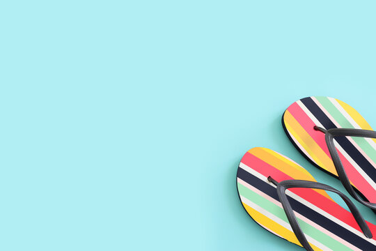 vacation and summer image with colorful flipflops over blue background