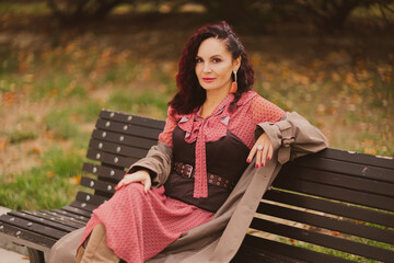 A woman walks outdoors in autumn, enjoys the autumn weather.