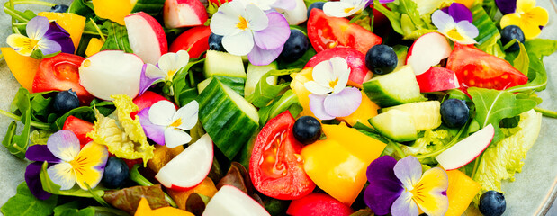 Salad with edible flowers, close up.