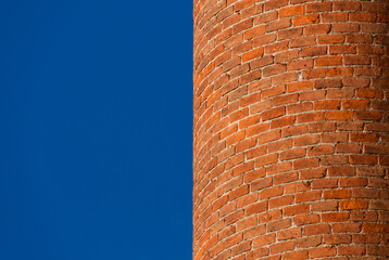 Curved brick wall with blue sky as background (with copy space)