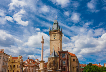 Old Town Hall medieval clock tower among clouds in Prague, a city landmark erected in 1364 in Old Town Square, with Marian Column - 609579096