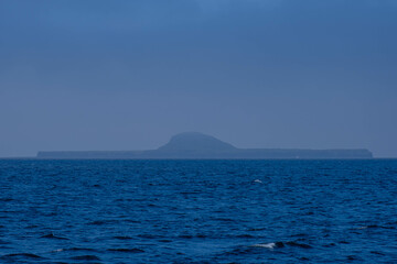 Naklejka na ściany i meble An island on the West Coast of Scotland, full small island surrounded by ocean