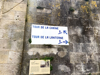 Direction signs of the Chain Tower and the Lantern Tower in the Rue sur les Murs pedestrian walkway in La Rochelle, France