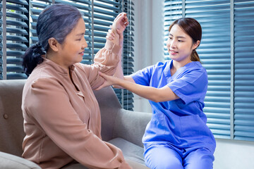 Asian physical therapist doctor is doing medical examination of elbow joint and bone of senior...
