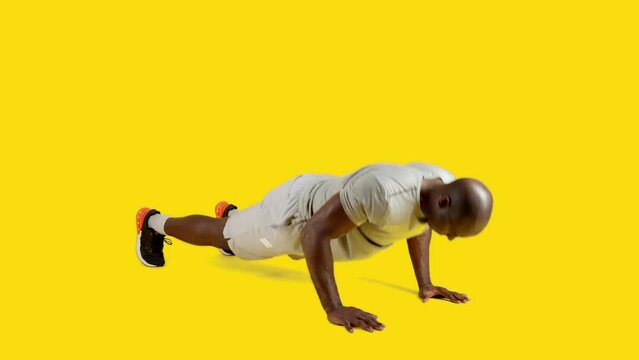 Strong and sportive african man doing push ups