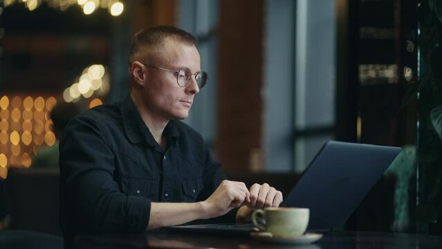 Work Remotely, Freelancer Man Sitting In Cafe With Laptop On Table, Portrait Of Businessman
