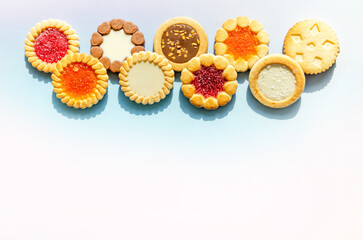 Round cookies on blue background, copy space for text. Flat lay, top view. food background