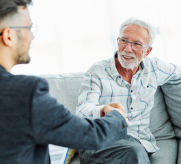 handshake senior man investment business finance elderly agent meeting agreement planning home happy insurance house client retirement deal adviser man hand