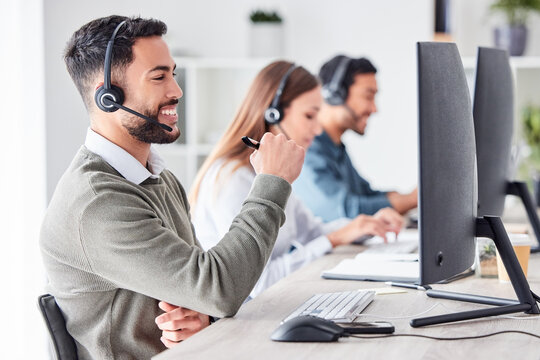 Man, call center and working in team office with headset, computer for online customer support, service or help. Businessman, employee and job in crm, telemarketing or communication help desk