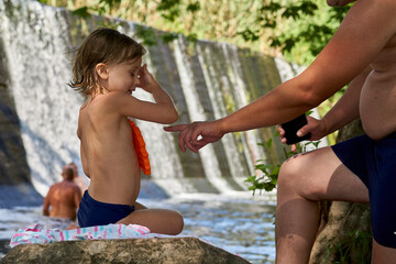 Dad tells the girl daughter that you need to be careful near the water