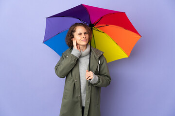 English woman holding an umbrella isolated on purple background having doubts