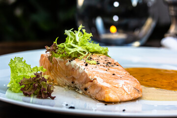 grilled salmon steak with mash potatoes and tomato sauce on plate