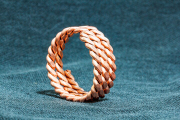 Old fashioned Sailors rope ring made of twisted copper - stock photo