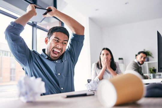 Angry, hitting and business man in office for anger management problem, mental health and frustrated. Shout, technology and burnout or stress of professional person with employees fear and shocked