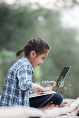 A girl is using a laptop computer for education and learning online.