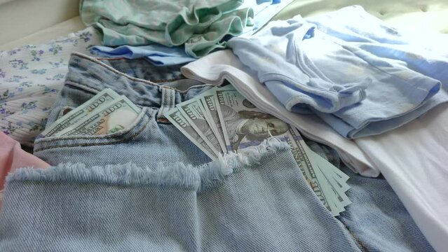 Blue jeans with American dollars in the pocket, top view. Concept of traveling or shopping