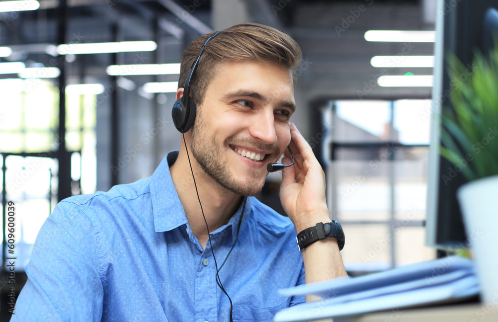 Wall mural smiling friendly handsome young male call centre operator