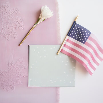 Top view with greeting card, white flower and American flag for event celebration