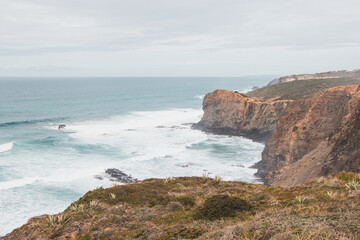 Portugal's western coastline of rocky cliffs and sandy beaches in the Odemira region. Wandering along the Fisherman trail on rainy days